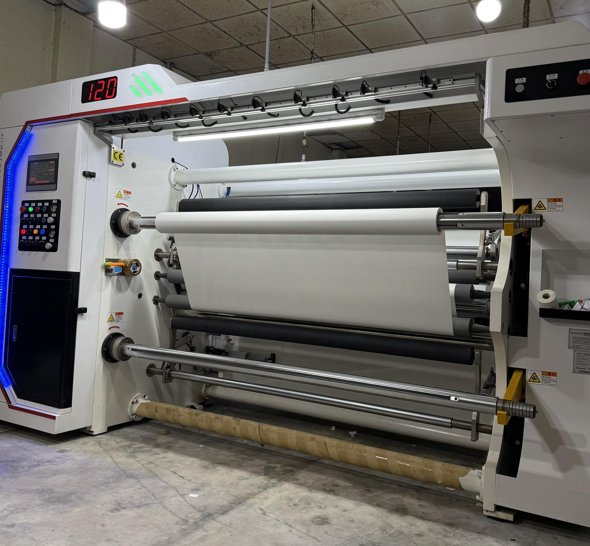 EvoXgear roller heat transfer machine applying high-quality prints on Boxing, MMA, BJJ, and Fightwear fabrics.